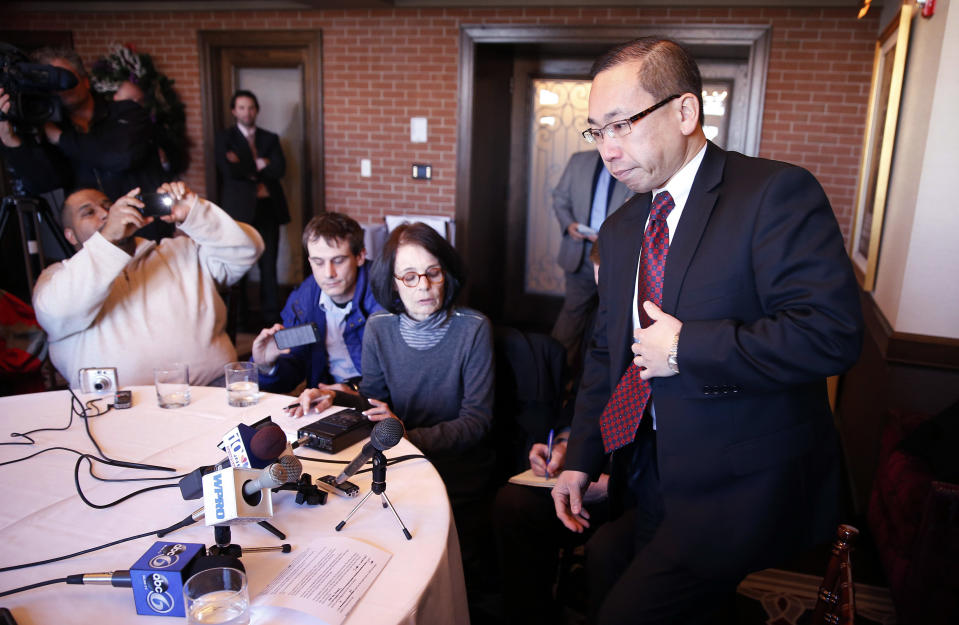 Cranston Rhode Island Mayor Allan Fung, right, takes his seat after briefly stepping out of the room while speaking with reporters during a news conference at the Chapel Grill in Cranston, Monday, Jan. 13, 2014. Fung, a leading Republican candidate for Rhode Island governor disclosed on Monday that he was responsible for a crash that killed a man 25 years ago. (AP Photo/Michael Dwyer)