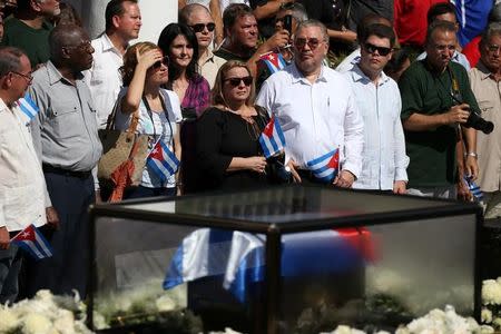 FILE PHOTO: Fidel Castro Diaz-Balart (fourth from R, holding flag), son of Cuba's late President Fidel Castro, joins people lining a street to watch as the caravan carrying the ashes of Fidel Castro arrives in Santiago de Cuba, Cuba, December 3, 2016. REUTERS/Carlos Garcia Rawlins/File Photo