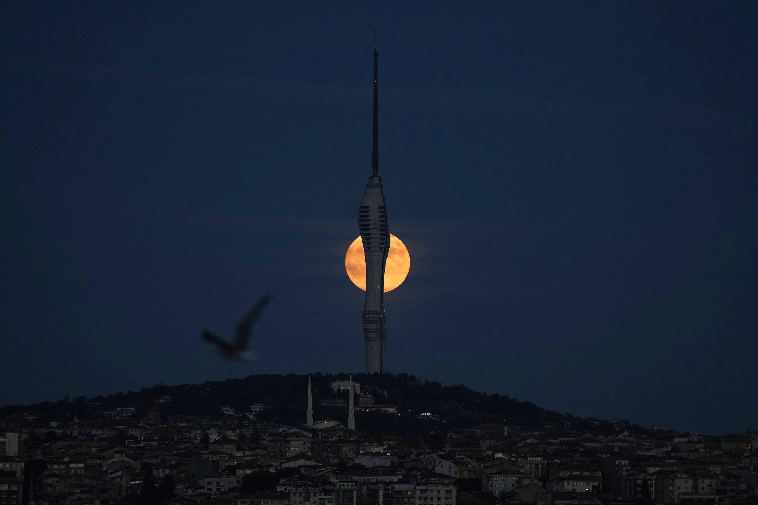 A supermoon rises behind Camlica tower in Istanbul on Tuesday.