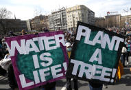 People hold banners during a protest in front of the Serbian Parliament building in Belgrade, Serbia, Saturday, April 10, 2021. Environmental activists are protesting against worsening environmental situation in Serbia. (AP Photo/Darko Vojinovic)