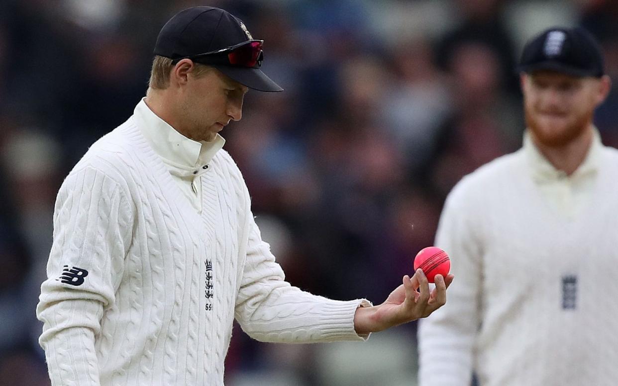Joe Root examines a pink ball during a Test match at Edgbaston - Nick Potts/PA