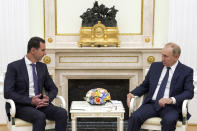 Russian President Vladimir Putin, right, listens to Syrian President Bashar Assad during their meeting in the Kremlin in Moscow, Russia, Monday, Sept. 13, 2021. (Mikhail Klimentyev, Sputnik, Kremlin Pool Photo via AP)