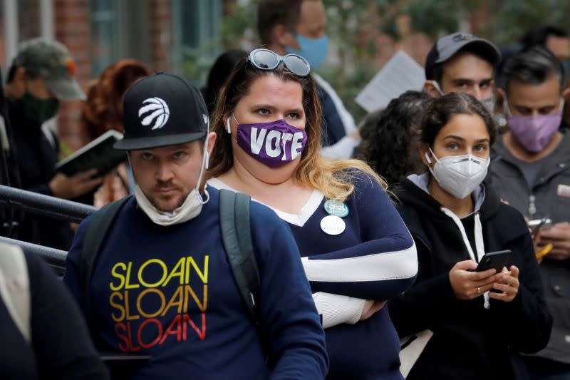 FILE PHOTO: Voters wait in line for several hours to cast their ballots during early voting in Brooklyn New York