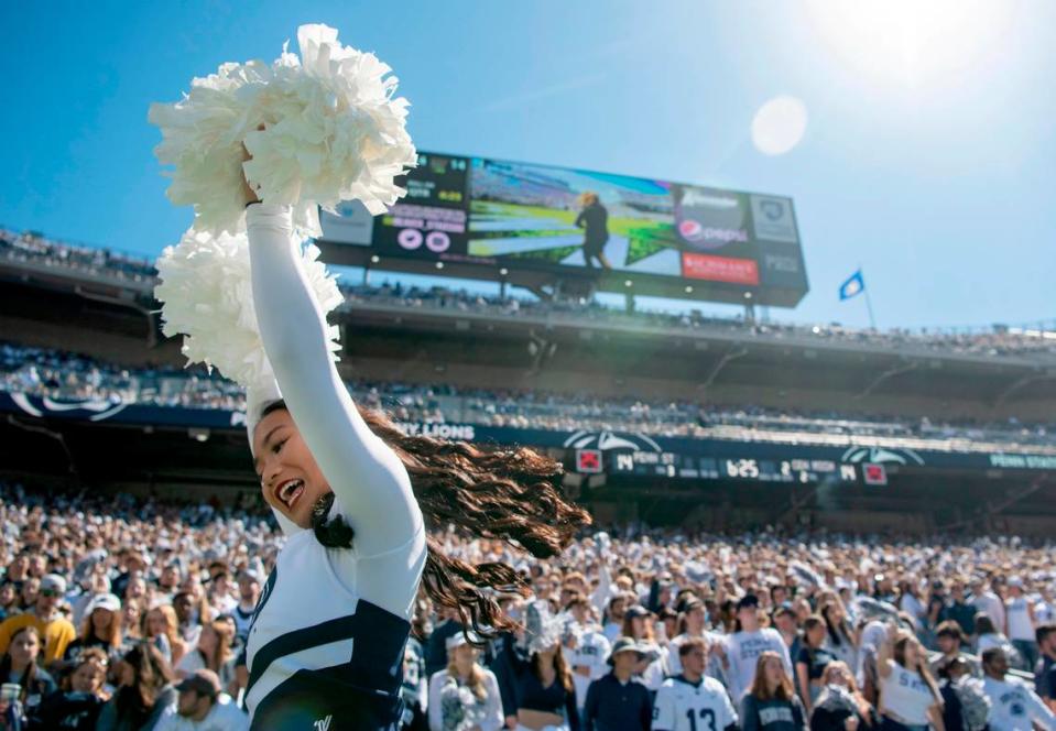 A Penn State cheerleader spins around and pumps up the crowd during the game against Central Michigan on Saturday, Sept. 24, 2022.