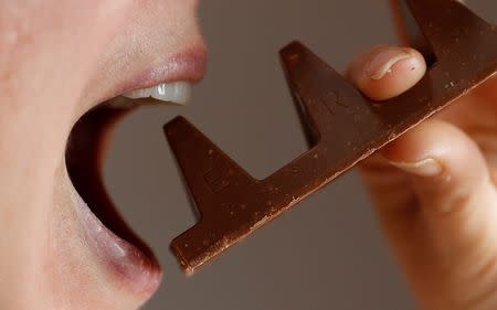 FILE PHOTO: A woman poses with a 150g of Toblerone chocolate in Loughborough, Britain, November 8, 2016. REUTERS/Darren Staples/File Photo