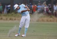 Rickie Fowler of the U.S. hits his approach shot from the 12th fairway during the first round of the U.S. Open Championship golf tournament in Pinehurst, North Carolina, June 12, 2014. REUTERS/Mike Segar