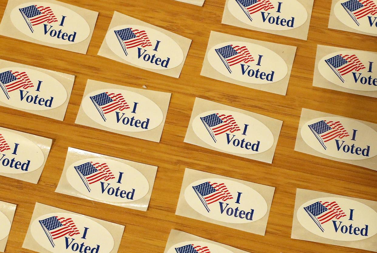 I Voted stickers are spread out on a table next to the ballot drop box for in-person voting at ​the Marvin Williams Recreation Center in Bremerton on Tuesday, Nov. 3, 2020.