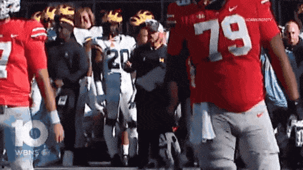 Connor Stalions, middle wearing a baseball hat, can be seen on the Michigan sideline. (@AdamKing10TV/X) 