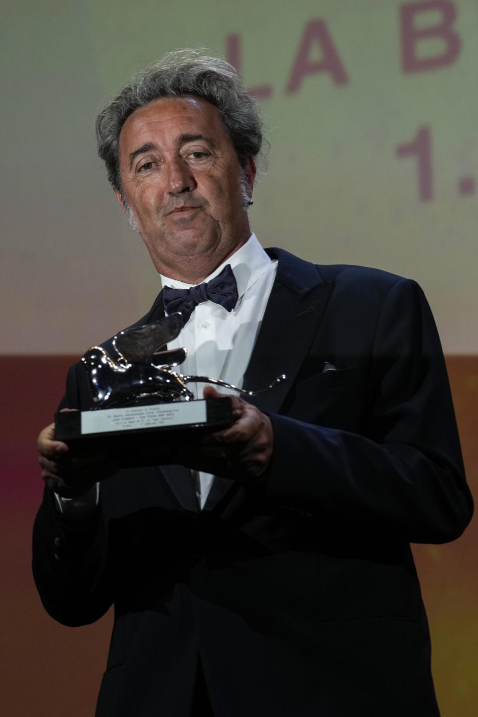 Paolo Sorrentino holds the Silver Lion Grand Jury Prize for 'The Hand Of God' onstage at the closing ceremony during the 78th edition of the Venice Film Festival in Venice, Italy, Saturday, Sept. 11, 2021. (AP Photo/Domenico Stinellis)