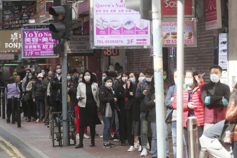 People queue up to buy face masks at a cosmetics shop in Hong Kong, Saturday, Feb, 1, 2020. China has moved to lock down at least three big cities in an unprecedented effort to contain the deadly new virus that has sickened hundreds of people and spread to other parts of the world. (AP Photo/Achmad Ibrahim)