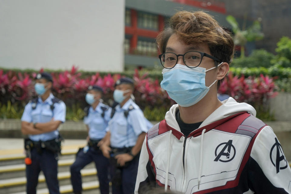 Various defendants including pro-democracy activist Figo Chan Ho-wun arrives at a court in Hong Kong, Monday, May 17, 2021. Trial starts for Jimmy Lai and nine others, accused of "incitement to knowingly take part in an unauthorized assembly" for a protest march on 1 October 2019. The court has estimated 10 days for this trial. (AP Photo/Kin Cheung)