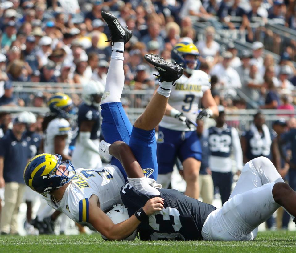 Delaware quarterback Zach Marker is upended by Penn State defensive end Dani Dennis-Sutton in the second quarter at Beaver Stadium, Saturday, Sept. 9, 2023 in University Park, Pa.