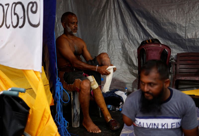 Sri Lankan war veteran puts on prosthetic leg at anti-government protest site amid economic crisis