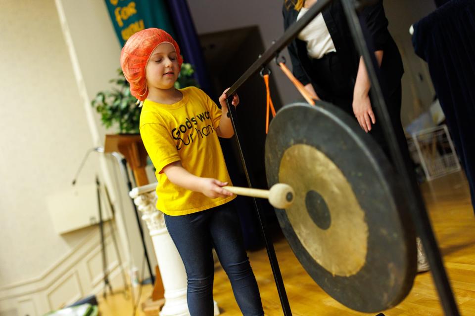 A child rings a gong to mark 28,000 meals packed during a meal-packing event held by Hanover Against Hunger, Saturday, Nov. 4, 2023, at St. Matthew's Church in Hanover. Over 600 volunteers took part in the event, which raised enough money to pack over 200,000 meals.