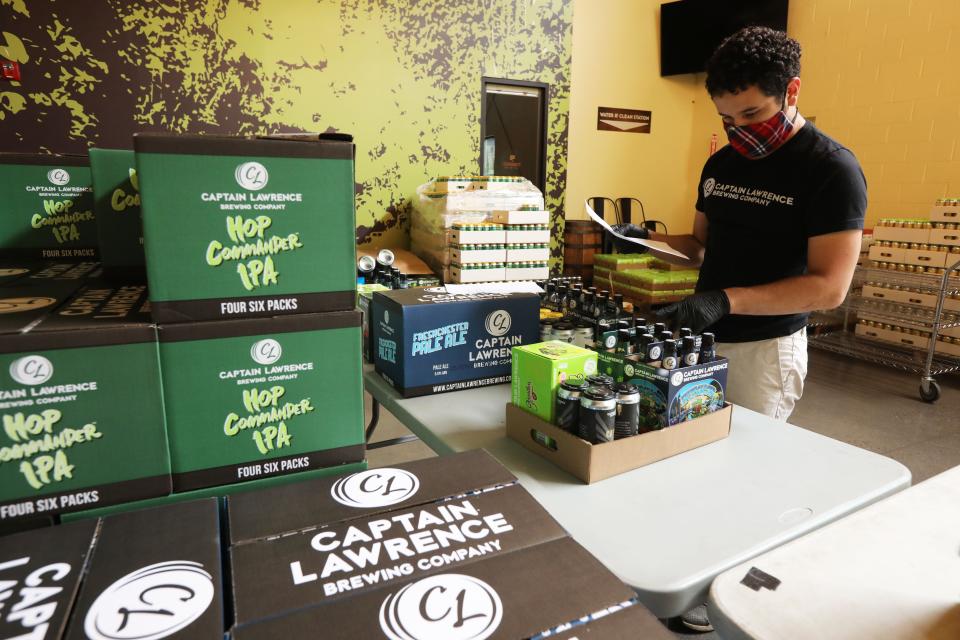 Andres Sanchez builds customer orders for pick-up and delivery at Captain Lawrence Brewery in Elmsford June 3, 2020 which has been offering pick-up and delivery direct to consumers since the pandemic hit and they were forced to close their beer hall.