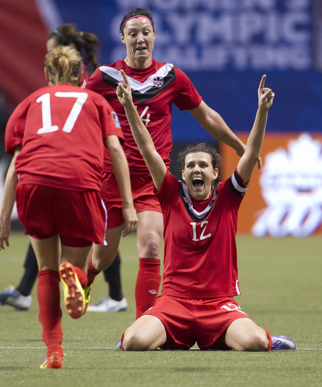 VANCOUVER, CANADA - JANUARY 27: Christine Sinclair #12 of Canada celebrates with teammates Melissa Tancredi #14 and Brittany Timko #17 after defeating Mexico 3-1 in the semifinals of the 2012 CONCACAF WomenÕs Olympic Qualifying Tournament at BC Place on January 27, 2012 in Vancouver, British Columbia, Canada. Canada qualifies for the 2012 Summer Olympic Games with the win. (Photo by Rich Lam/Getty Images)