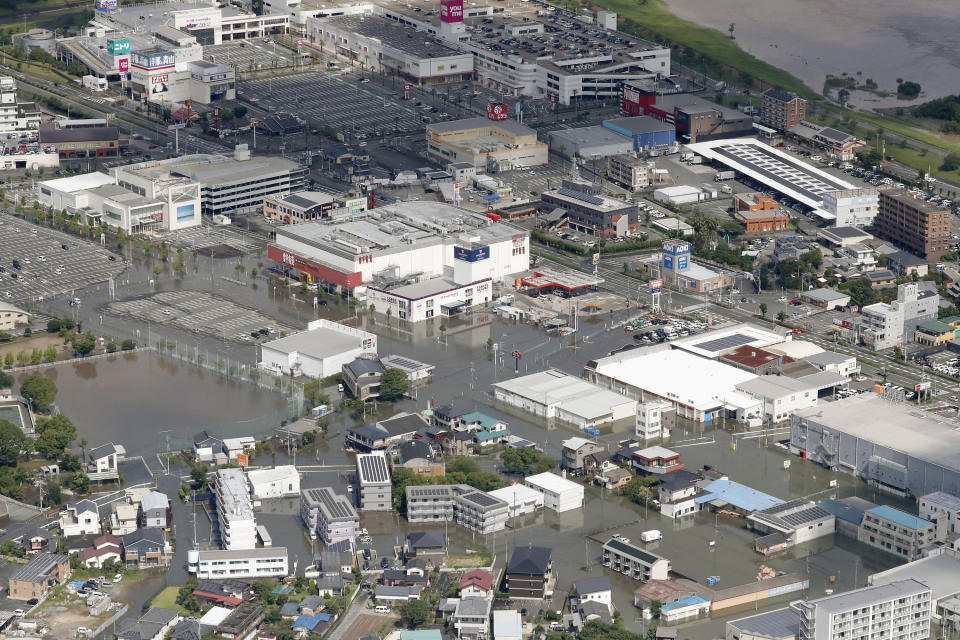 Streets are flooded following a heavy rain in Kurume, Fukuoka prefecture, southern Japan Wednesday, July 8, 2020. Floodwaters flowed down streets in southern Japanese towns hit by heavy rains. (Kyodo News via AP)