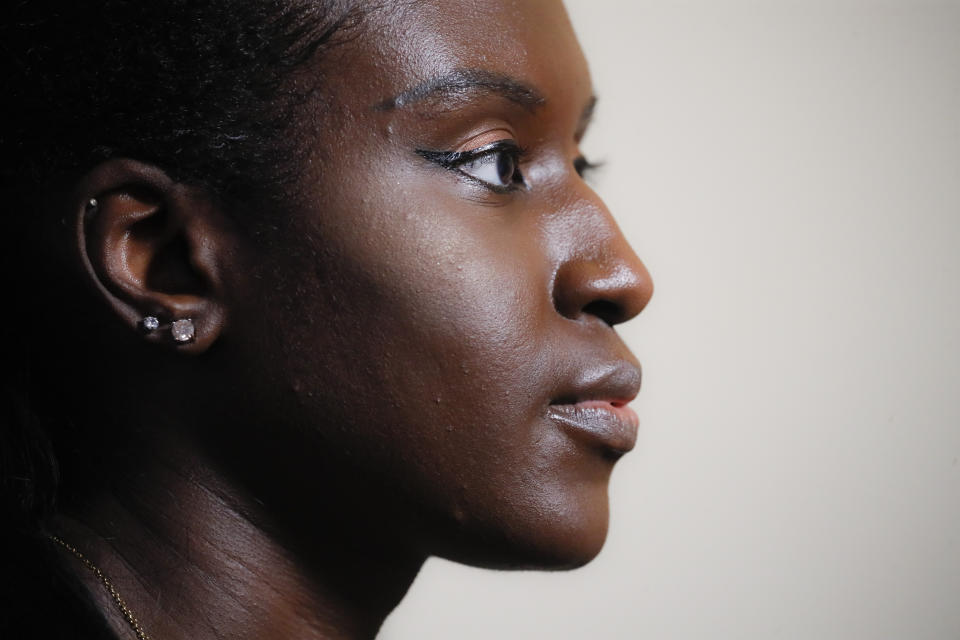 Maryama Diaw, a contact tracer with New York City's Health + Hospitals battling the coronavirus pandemic, works at her home before reaching out to potential patients Wednesday, Aug. 5, 2020, in New York. The city has hired more than 3,000 tracers and the city says it's now meeting its goal of reaching about 90% of all newly diagnosed people and completing interviews with 75%. (AP Photo/John Minchillo)