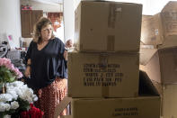 Ginger Pigg in her gift boutique The Perfect Pigg in Cumming, Ga. on Thursday afternoon, Oct. 22, 2021. She says she is struggling to get products to her store in a timely way. The boxes in the foreground are shopping bags that took 14 weeks to arrive when they normally would have arrived in 4 weeks. (AP Photo/Ben Gray)