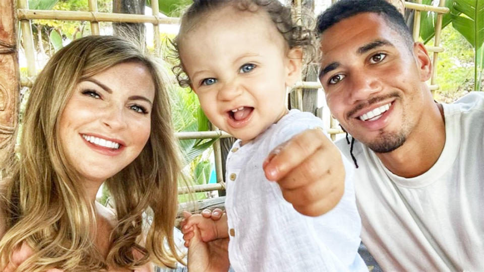 Pictured here, Roma defender Chris Smalling, his wife and young son.