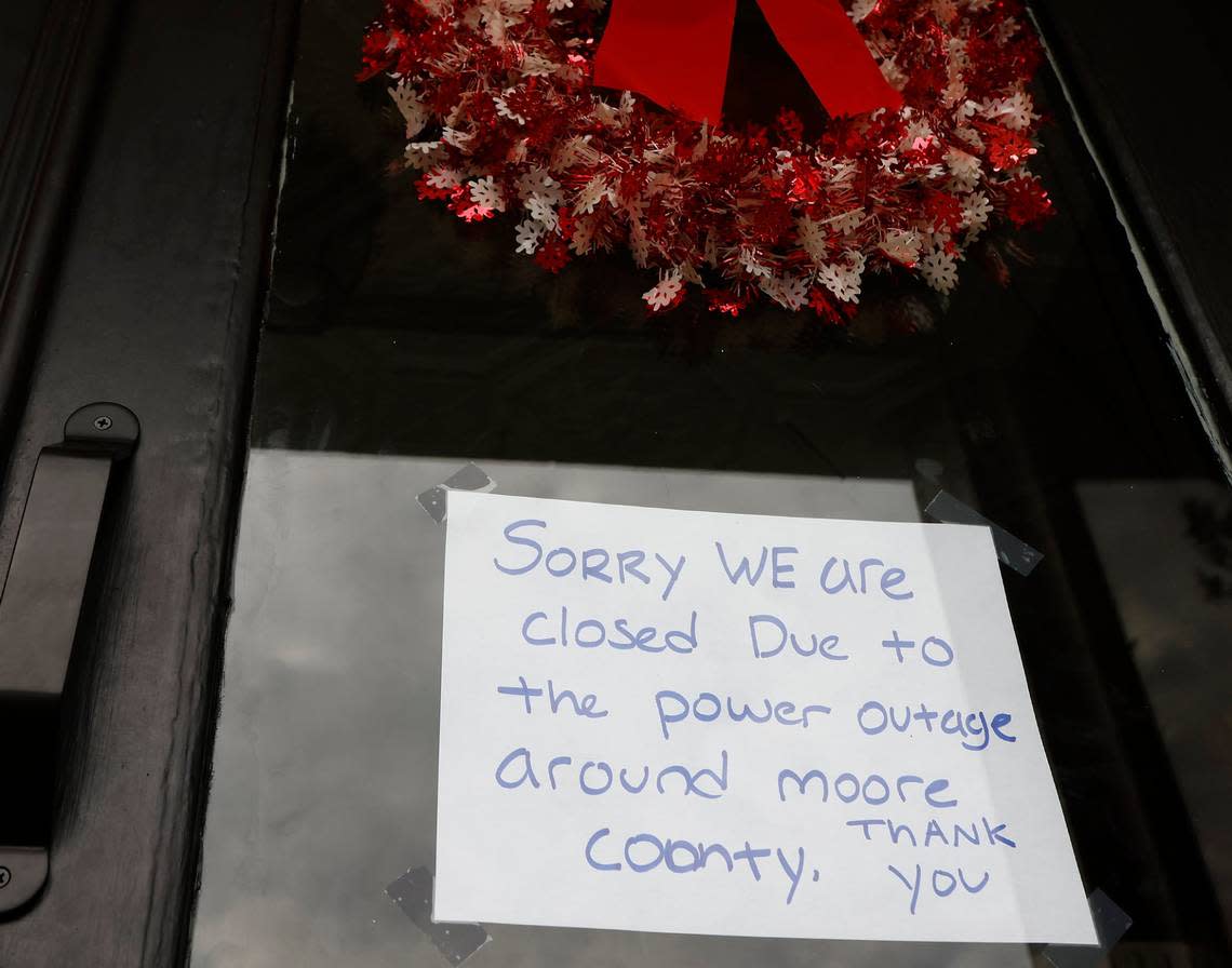 A sign on the door of Betsy’s Crepes alerts customers to its closure due to a power outage on Monday, Dec. 5, 2022, in Southern Pines, N.C. Kaitlin McKeown/kmckeown@newsobserver.com