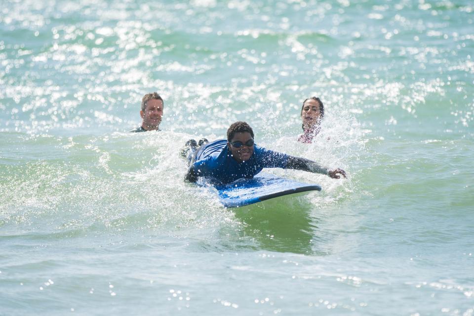 <p>Freedom: Casey, 12, enjoys some surf with the City to Sea Wave Project, which gives London children lessons to help improve their wellbeing</p> (Handout)