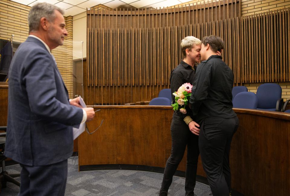 U.S. District Court Judge Michael McShane, left, officiates the marriage of Elliot Sullivan, center, and Lee Andersen during a special Love is Love Celebration in honor the tenth anniversary of Judge McShane’s ruling that Oregon’s exclusion of same-sex couples from marriage was unconstitutional.