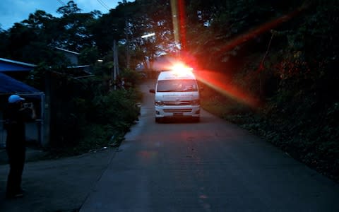  An ambulance believed to be carrying rescued schoolboys travels to a military helipad - Credit:  SOE ZEYA TUN/ REUTERS