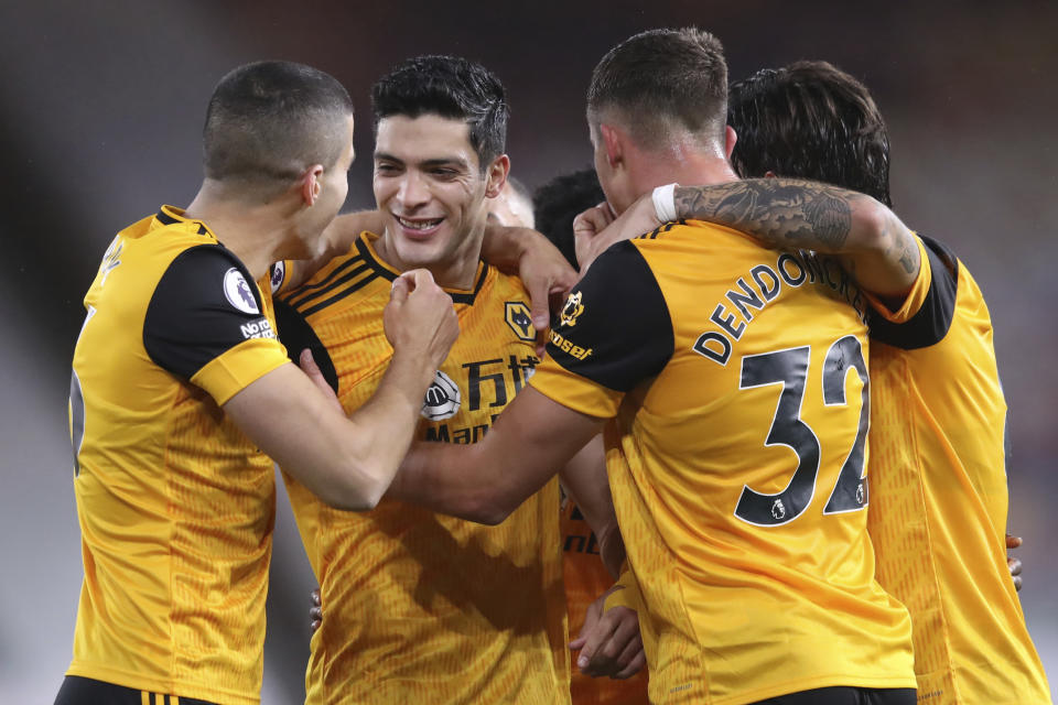 Wolverhampton Wanderers' Raul Jimenez, second left, celebrates after scoring his side's opening goal during the English Premier League soccer match between Wolves and Newcastle United at Molineux Stadium in Wolverhampton, England, Sunday, Oct. 25, 2020. (Alex Pantling/Pool Photo via AP)