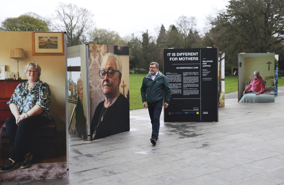Mark Thompson, from Relatives for Justice, walks at the photo exhibition in Belfast, Northern Ireland, Wednesday, April 5, 2023. It has been 25 years since the Good Friday Agreement largely ended a conflict in Northern Ireland that left 3,600 people dead. (AP Photo/Peter Morrison)