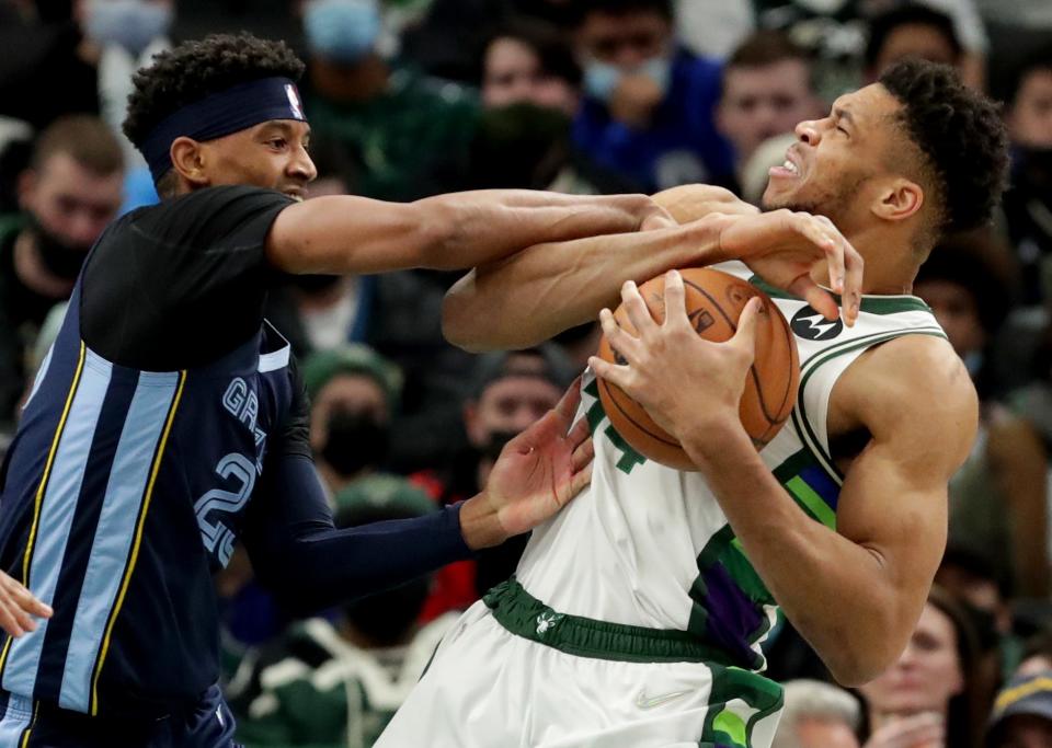 Bucks forward Giannis Antetokounmpo keeps the ball away from Grizzlies guard Jarrett Culver  during the second half Wednesday night at Fiserv Forum.