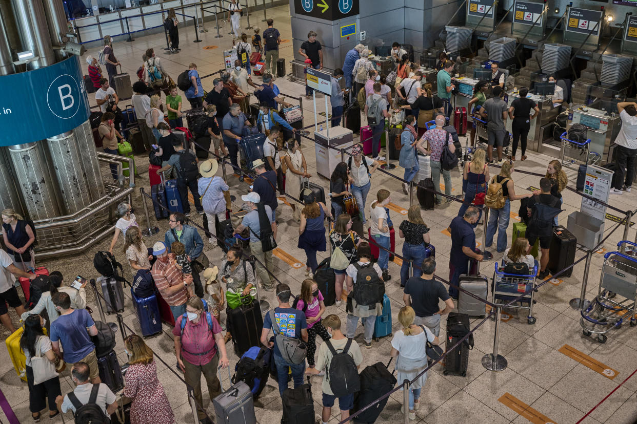 LISBON, PORTUGAL - JULY 09: Travelers crowd Terminal 1 departures hall while queueing at Lufthansa-Swiss check-in counters in Humberto Delgado International Airport on July 09, 2022 in Lisbon, Portugal. The city's airport has returned to normal after the forced inactivity due to the COVID-19 Coronavirus pandemic, and large numbers of travelers meant delays and recriminations from the government to SEF and ANA, in charge of handling departing and arriving passengers. INE attributes to the strong recovery dynamics in tourism an important part of the country's economic growth. Compared to the first quarter of 2021 -when Portugal was practically paralyzed by the pandemic-, domestic demand increased by 9.8%, exports by 18.3%, and imports by 13.1%. Portugal's economy grew 2.6% in the first quarter compared to the last one of 2021 -and 11.9% compared to the same period of the previous year-, thanks to the end of COVID-19 Coronavirus restrictions and a strong growth in private consumption. (Photo by Horacio Villalobos#Corbis/Corbis via Getty Images)