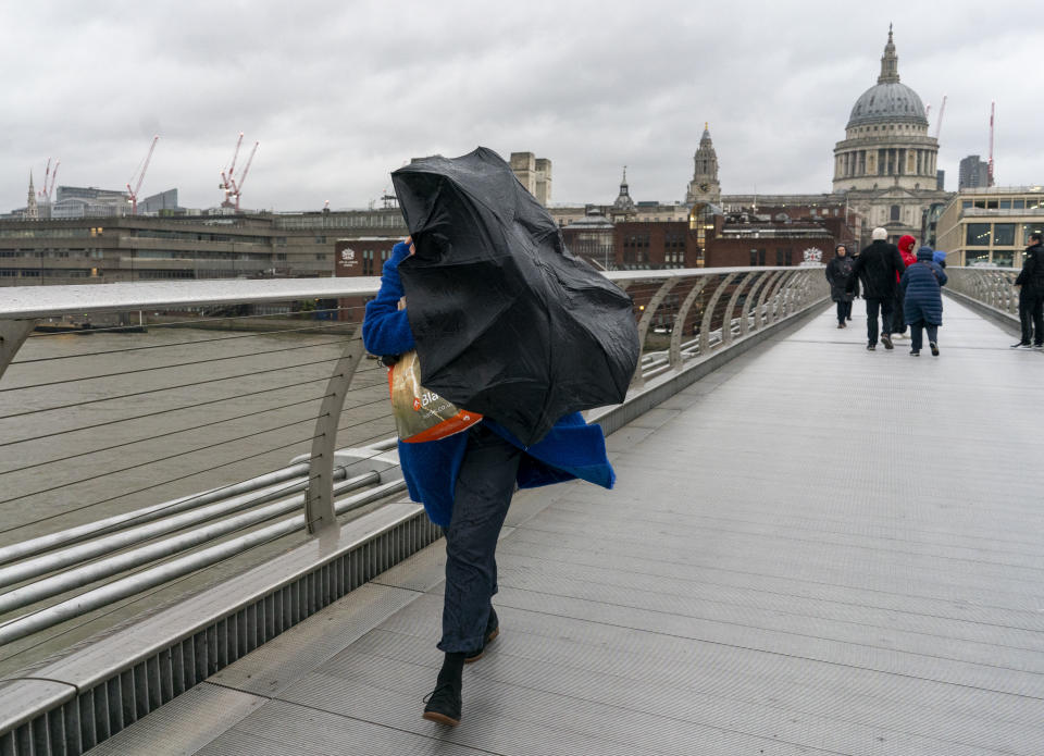 People brave the weather crossing the Millennium Bridge in London. Storm Gerrit will bring strong winds and heavy rain to many parts of the UK on Wednesday, with wintry hazards also likely, forecasters warned. Picture date: Wednesday December 27, 2023. (Photo by Jeff Moore/PA Images via Getty Images)