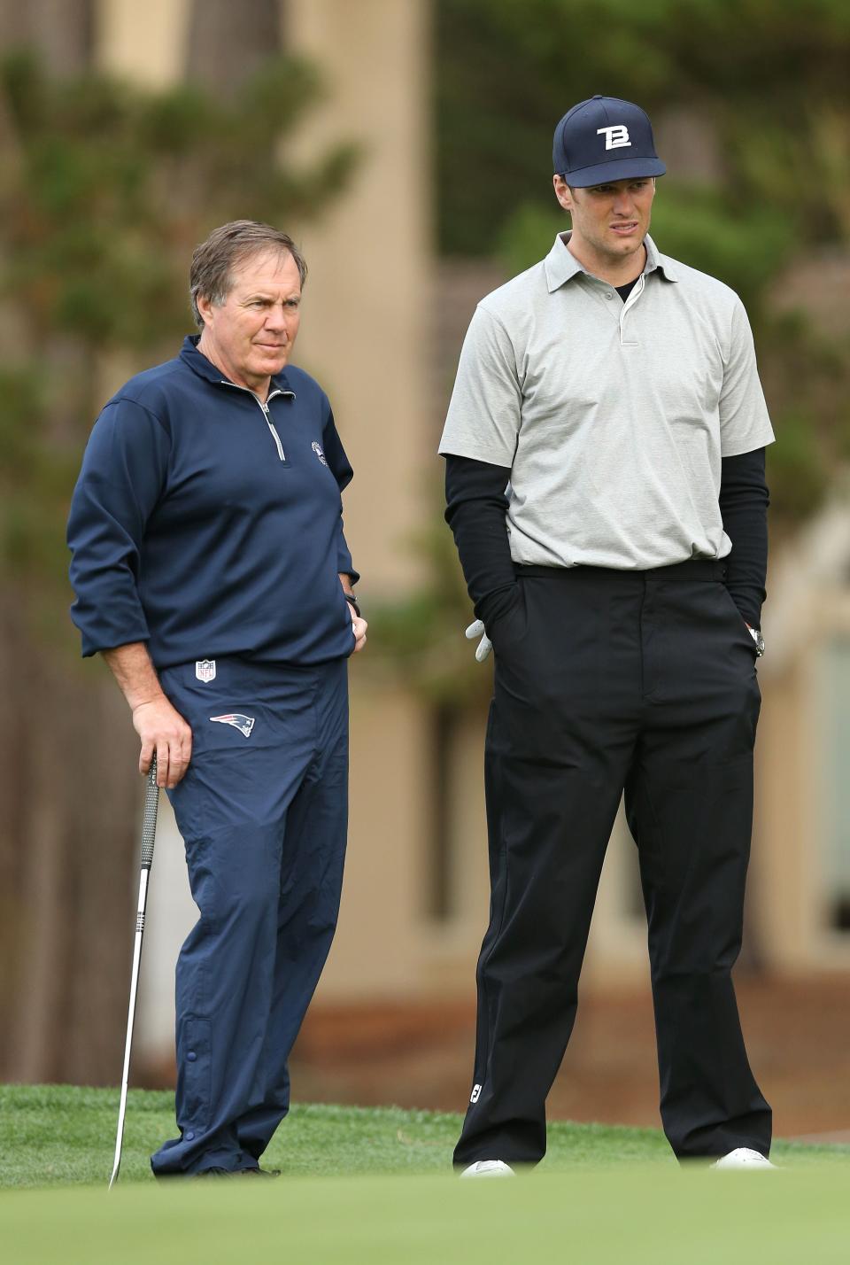 PEBBLE BEACH, CA - FEBRUARY 06:  NFL football coach Bill Belichick and professional football player Tom Brady stand on the 17th hole green during the first round of the AT&T Pebble Beach National Pro-Am at Spyglass Hill Golf Course on February 6, 2014 in Pebble Beach, California.  (Photo by Christian Petersen/Getty Images)