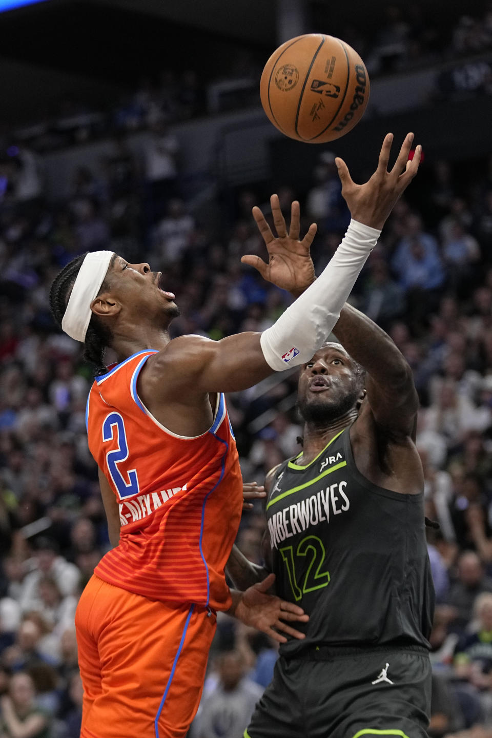 Oklahoma City Thunder guard Shai Gilgeous-Alexander (2) loses control of the ball while defended by Minnesota Timberwolves forward Taurean Prince (12) during the second half of an NBA basketball play-in tournament game Friday, April 14, 2023, in Minneapolis. (AP Photo/Abbie Parr)