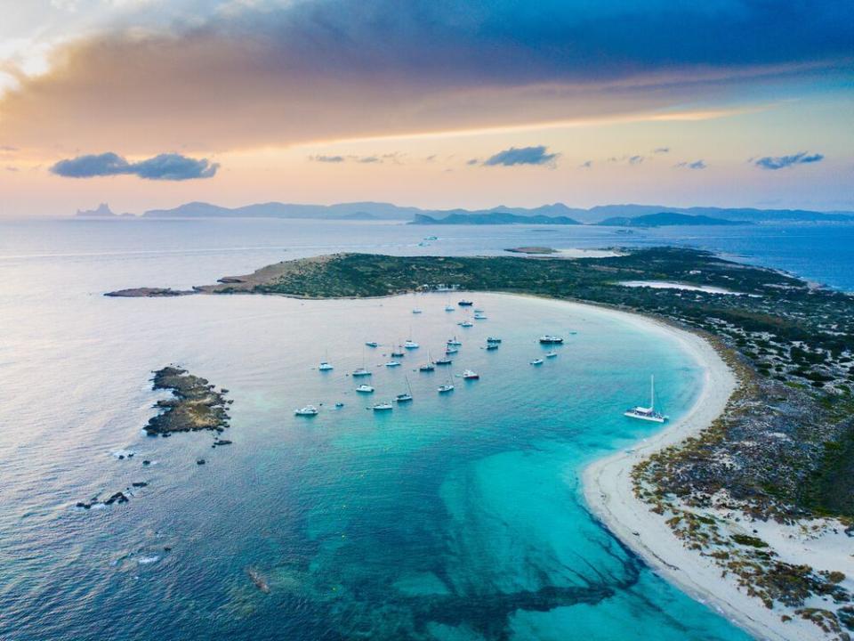 a beach with many boats