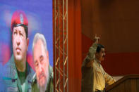 <p>Venezuelan President Nicolas Maduro speaks in front of images of Venezuela’s late President Hugo Chavez and Cuba’s late President Fidel Castro, during a celebration of the 12th anniversary of the creation of the Bolivarian Alliance for the Peoples of Our America – Peoples’ Trade Treaty (ALBA-TCP), in Havana. Dec. 14, 2016. (Alexandre Meneghini/Reuters) </p>