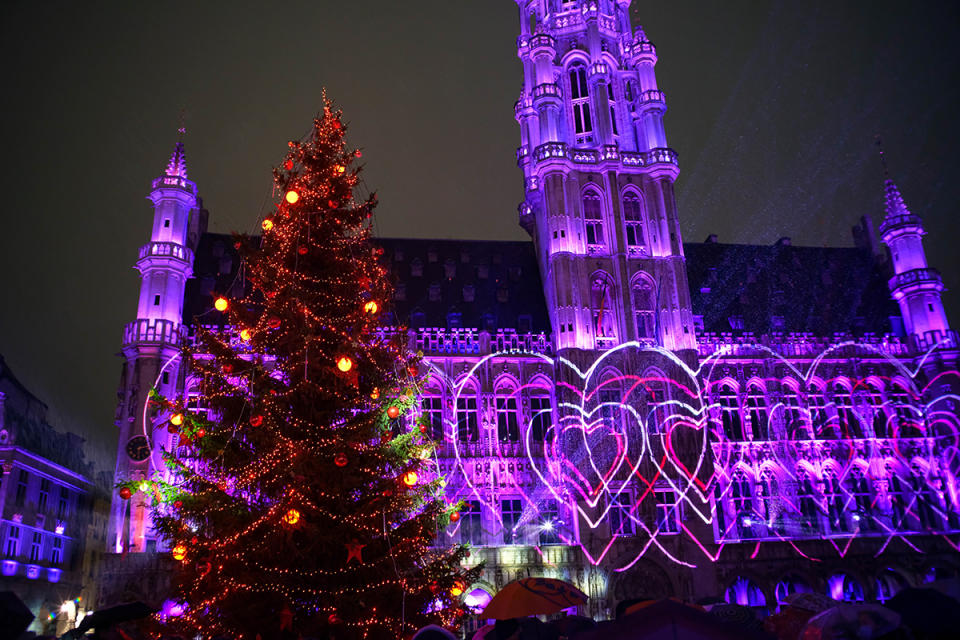 best christmas markets around the world, Photo taken on Nov. 26, 2021 shows a giant Christmas tree and the sound and light show at the Grand Place during the Winter Wonders in Brussels, Belgium. Featuring activities like the sound and light show, Christmas market and so on, the Winter Wonders 2021 in Brussels started on Friday. With rising numbers of COVID-19 cases, strict measures were imposed during the event, such as checking COVID Safe Tickets, wearing face masks and keeping distance. (Photo by Zhang Cheng/Xinhua via Getty Images)