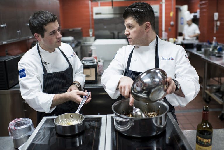 Commis Corey Siegel (L) listens to Chef Richard Rosendale while they practice in The Bunker below the Greenbrier Resort in White Sulphur Springs, West Virginia, on January 10, 2013. Rosendale, who runs the Greenbrier Resort's food operations, including its 13 restaurants, and Siegel will represent the US in the 2013 Bocuse D'Or, a biennial world chef championship in Lyon, France, end of January