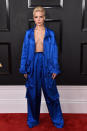 <p>Now <i>that’s</i> a jumpsuit! The 22-year-old singer went braless in this open-shirt “90s R&B” inspired satin jumpsuit. </p>