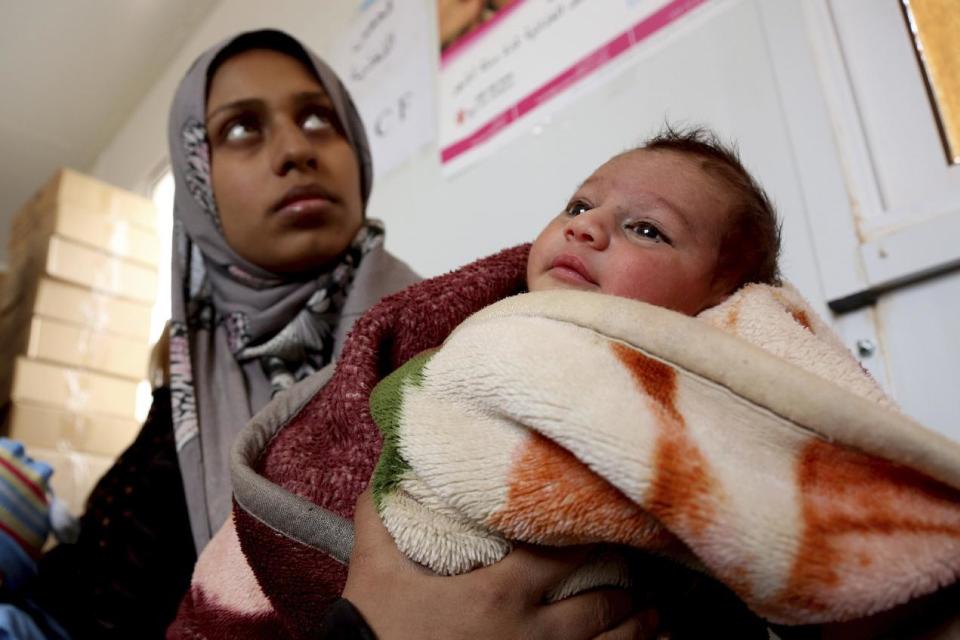 In this Tuesday, Feb. 14, 2017 photo, a Syrian child from the informal, Rukban border camp, north east of Jordan's border with Syria, receives treatment in a clinic run by UNICEF inside the Jordanian territories. The commander of Jordan's border guards says Islamic State extremists are expanding their influence in a sprawling border camp for tens of thousands of displaced Syrians, posing a growing threat to the U.S.-allied kingdom. (AP Photo/ Raad Adayleh)