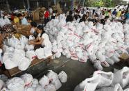 Volunteers packed a relief goods inside a Department of Social Welfare and Development warehouse before shipping out to devastated provinces hit by Typhoon Haiyan in Manila November 8, 2013. Typhoon Haiyan, the strongest typhoon in the world this year and possibly the most powerful ever to hit land battered the central Philippines on Friday, forcing millions of people to flee to safer ground, cutting power lines and blowing apart houses. Haiyan, a category-5 super typhoon, bore down on the northern tip of Cebu Province, a popular tourist destination with the country's second-largest city, after lashing the islands of Leyte and Samar with 275 kph (170 mph) wind gusts and 5-6 meter (15-19 ft) waves. REUTERS/Romeo Ranoco (PHILIPPINES - Tags: DISASTER ENVIRONMENT)