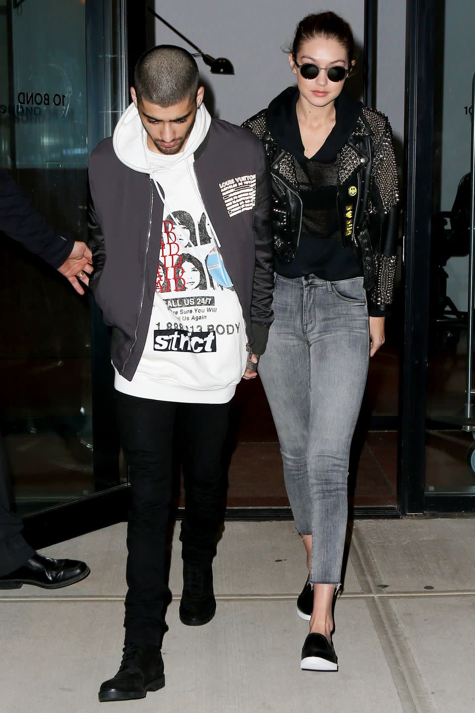 <p>Gigi Hadid left her NYC apartment with boyfriend Zayn Malik, dressed in a studded Burberry leather jacket, gray jeans and slip-on sneakers. </p>
