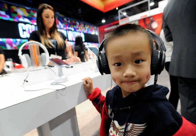 A young boy listens to music on a pair of headphones at the CES in Las Vegas on January 9, 2013. The technology industry displaying its wares at the massive Consumer Electronics Show this week included a variety of products and apps aimed at the youngest audiences, even those unable to walk