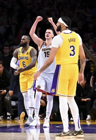 Nuggets center Nikola Jokic, center, celebrates after defeating LeBron James, left, Anthony Davis and the Lakers on May 22.