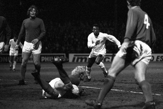 Fulham goalkeeper Peter Mellor dives at the feet of Pele in 1973
