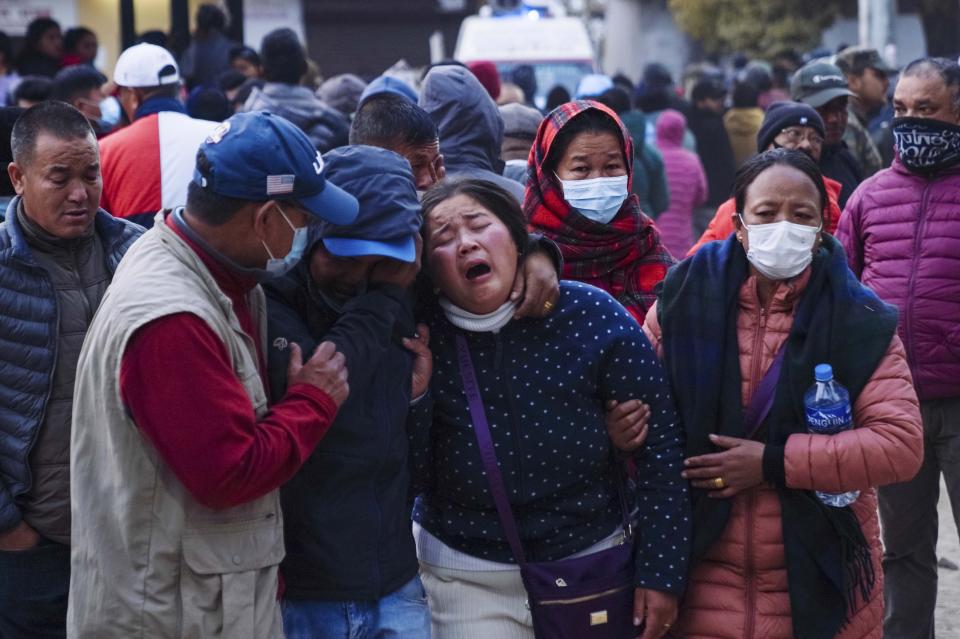 A woman cries as the body of a relative, victim of a plane crash, is brought to a hospital in Pokhara, Nepal, Sunday, Jan. 15, 2023. A plane making a 27-minute flight to a Nepal tourist town crashed into a gorge Sunday while attempting to land at a newly opened airport, killing at least 68 of the 72 people aboard. At least one witness reported hearing cries for help from within the fiery wreck, the country’s deadliest airplane accident in three decades. (AP Photo/Yunish Gurung)