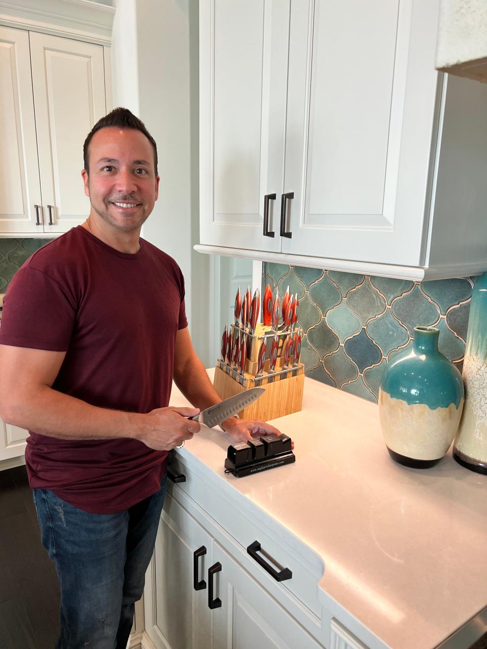 Backstreet Boy and Brevard resident Howie Dorough demonstrates how easy it is to use the Angle Pro 2 knife sharpener.