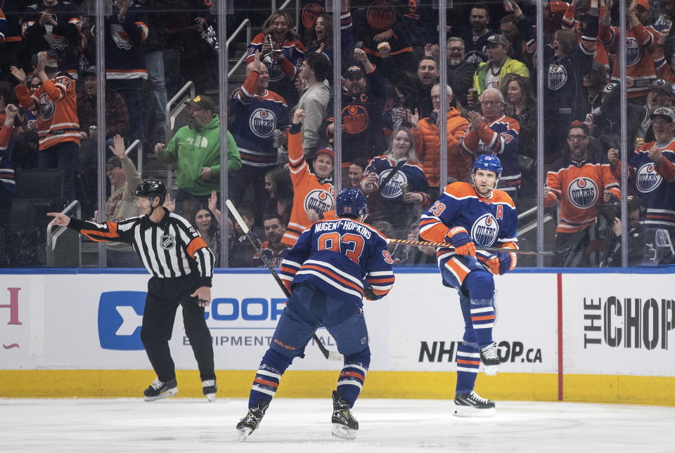 Edmonton Oilers' Ryan Nugent-Hopkins (93) and Leon Draisaitl (29) celebrate a goal against the Winnipeg Jets during the first period of an NHL hockey game Friday, March 3, 2023, in Edmonton, Alberta. (Jason Franson/The Canadian Press via AP)