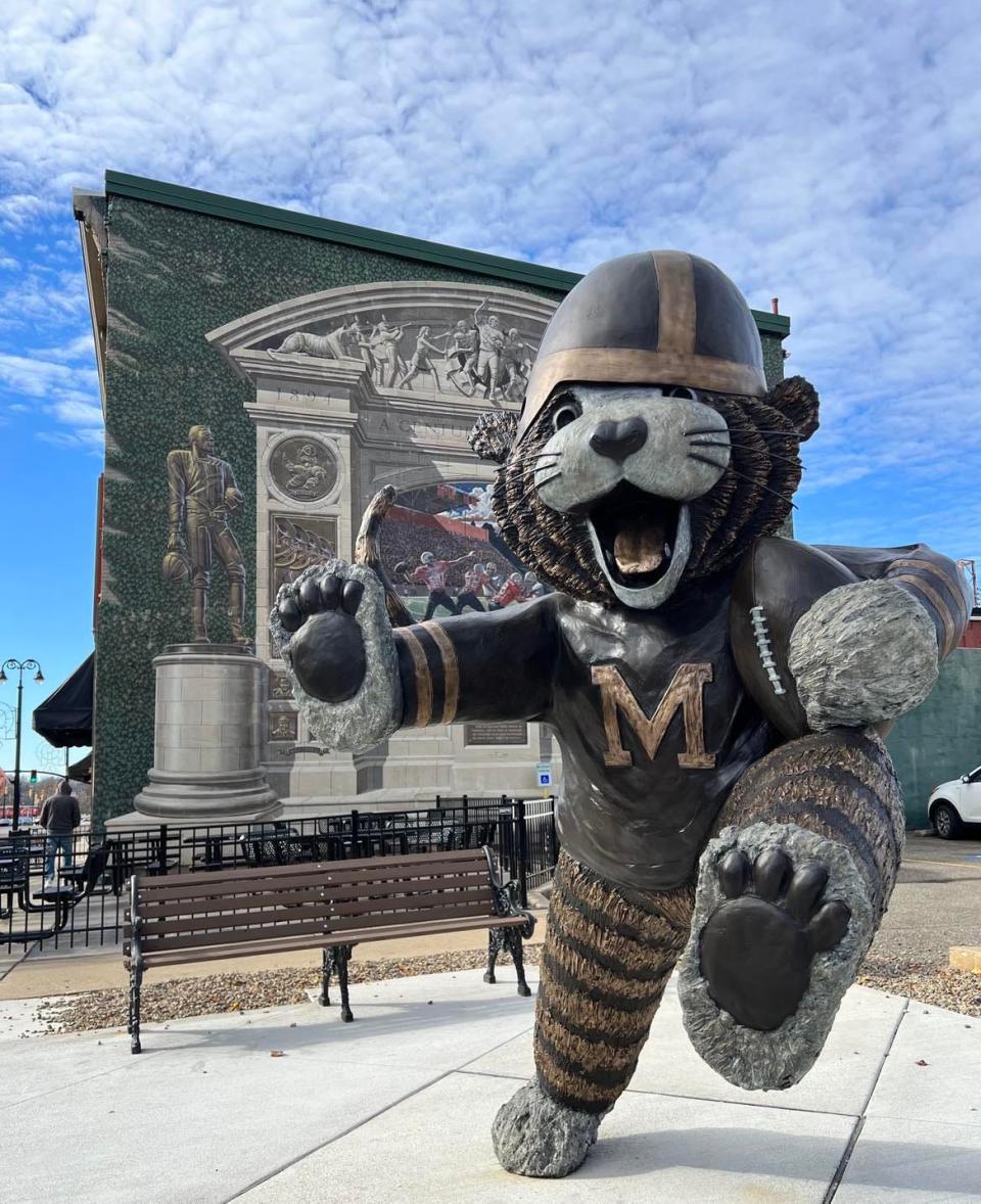 A Massillon Tigers statue is shown in downtown Massillon near a football-themed mural. The Massillon Tigers high school football team has advanced to the state finals against Hoban.